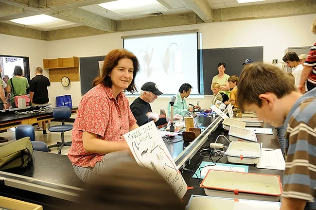Professor Sharon Lawler of the Department of Entomology and Nematology, greets guests at the aquatic display in Briggs Hall. (Photo by Kathy Keatley Garvey)