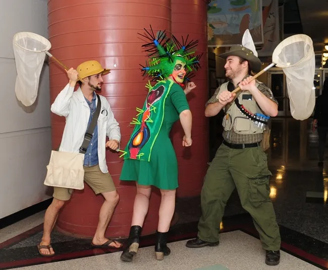 Bug catchers Wade Spencer (far left) and Brennen Dyer, both entomoogy students, try to net a venomous caterpillar--doctoral candidate Charlotte Herbert. (Photo by Kathy Keatley Garvey)