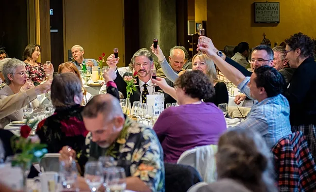 This was the scene at the UC Davis Honey and Pollination Center's 2016 Feast. At right (glasses, facing camera) is pollinator ecologist Neal Williams, associate professor of entomology, UC Davis Department of Entomology and Nematology. In the foreground (in purple and blue) are Extension apiculturist Elina Ni&ntilde;o and Bernardo Ni&ntilde;o of the Harry H. Laidlaw Jr. Honey Bee Research Facility. (Photo by Mick&rsquo;s Magic Moments)