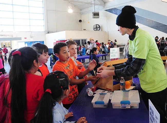 Eager third graders ask Parris McGrath if they can hold the Madagascar hissing cockroaches. (Photo by Kathy Keatley Garvey)
