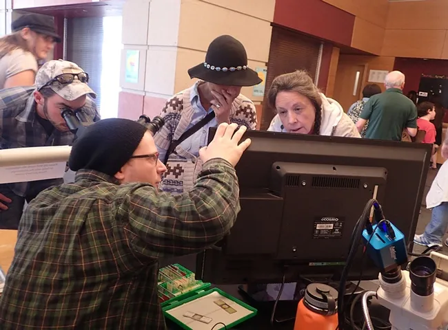 Nematologist and graduate student Corwin Parker talks about nematodes to visitors. (Photo by Kathy Keatley Garvey)