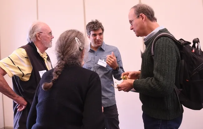 The panel of judges conferring. In the foreground is timer Mea McNeil. In back (from left) are judges Robbin Thorp and Santiago Ramirez of UC Davis, and Tom Seeley of Cornell. (Photo by Kathy Keatley Garvey)