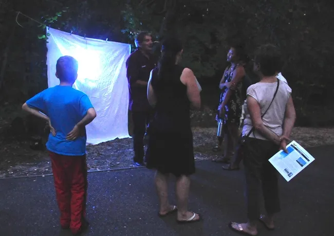 Standing in front of the blacklighting, Bohart associate Greg Kareofelas talks to moth enthusiasts at the 2017 Bohart Museum of Entomology Moth Night. (Photo by Kathy Keatley Garvey)