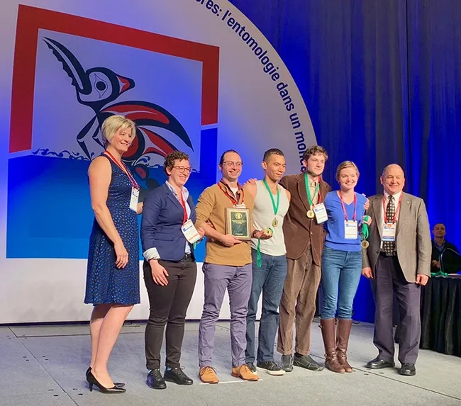 Gamemaster Deane Jorgensen (far left), research scientist at Sygenta, and ESA president Michael Parrella (far right), dean of the College of Agricultural and Life Sciences,  University of Idaho, flank the national Linnaean Games Team champions. In the center (from left) are Emily Bick, Brendon Boudinot, captain Ralph Washington Jr., Zachary Griebenow and Jill Oberski. Parrella is a former professor and chair of the UC Davis Department of Entomology and Nematology. (Joe Rominiecki Photo)