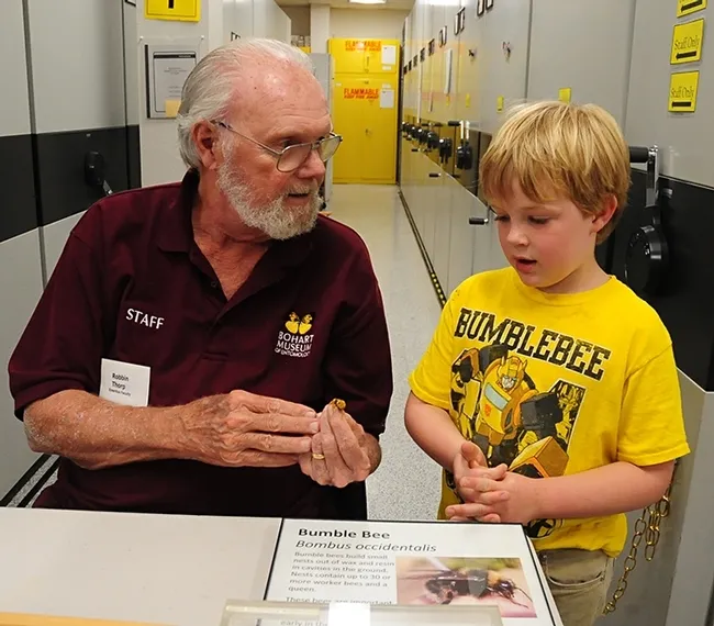 UC Davis distinguished emeritus professor Robbin Thorp, a global expert on bumble bees, chats with "Bumblebee" movie fan, Adne Buruss, at a Bohart Museum of Entomology open house. (Photo by Kathy Keatley Garvey)