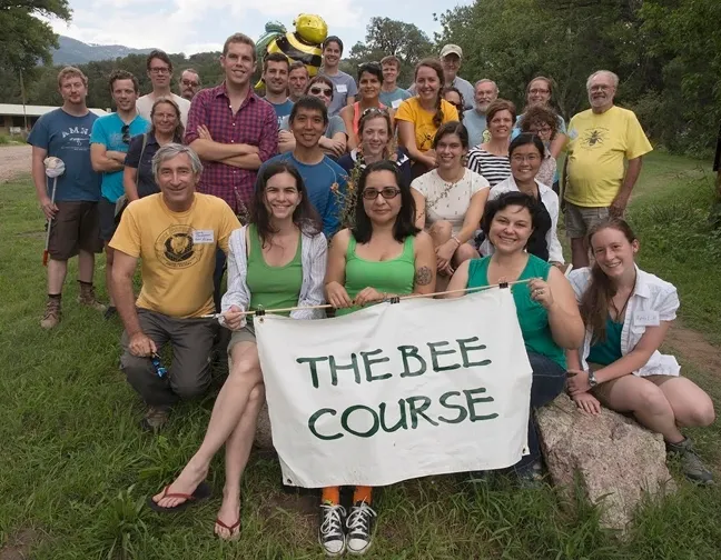 Robbin Thorp (standing, far right, yellow shirt), an instructor at The Bee Course, with students and fellow instructors.