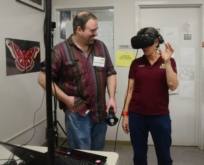 Lynn Kimsey, director of the Bohart Museum of Entomology, experiences Virtual Reality with spiders. "I just want to collect them," she said. With her is medical entomologist Geoffrey Attardo. (Photo by Kathy Keatley Garvey)