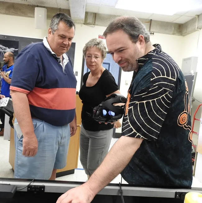 UC Davis alumnus Paul McClelland (zoology)of Sunnyvale selects what insect he wants to see in virtual reality. With him are his wife Marmirjam and UC Davis medical entomologist Geoffrey Attardo. (Photo by Kathy Keatley Garvey)