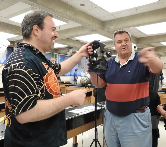 "That's fascinating!" said Paul McCelland, as he hands off the headphones to another member of his party. (Photo by Kathy Keatley Garvey)