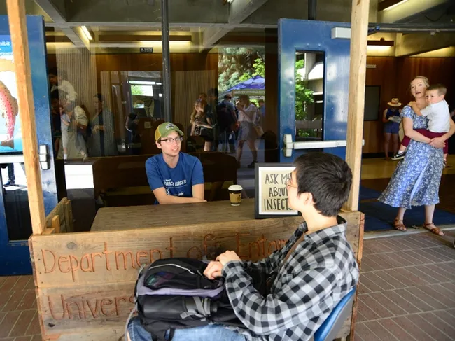 Miles Dakin, Ph.D. candidate in the Christian Nansen lab, fields a question about insects. (Photo by Kathy Keatley Garvey)