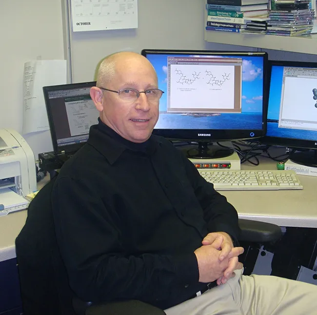 Thomas Sparks at his desk. He was the first graduate student of UC Davis distinguished professor Bruce Hammock.