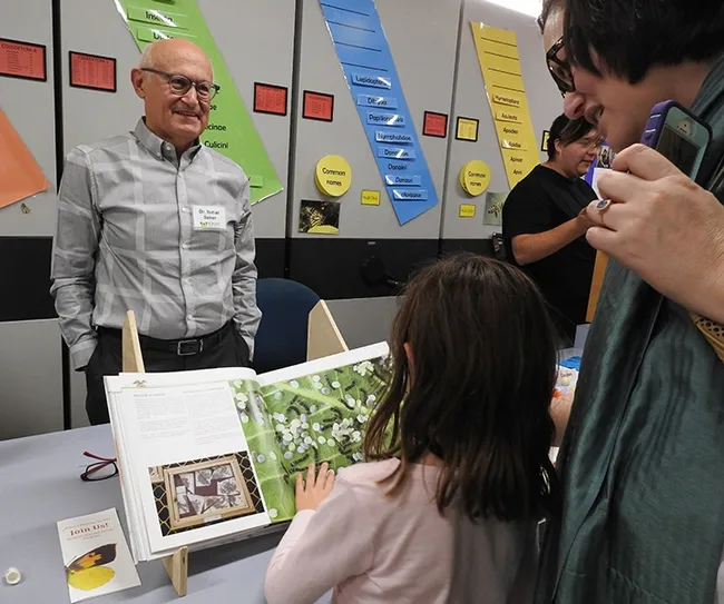 Silkworm moth expert, İsmail Şeker, a Turkish medical doctor and author of a silkworm moth book, answers questions from the crowd at the Bohart Museum open house. (Photo by Kathy Keatley Garvey)