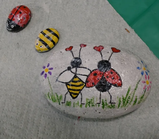 These rocks at the Bohart Museum of Entomology depict favorite insects: honey bees and ladybugs (lady beetles.) The larger rock, inspired by Valentine's Day, is titled "Love Bugs." (Photo by Kathy Keatley Garvey)