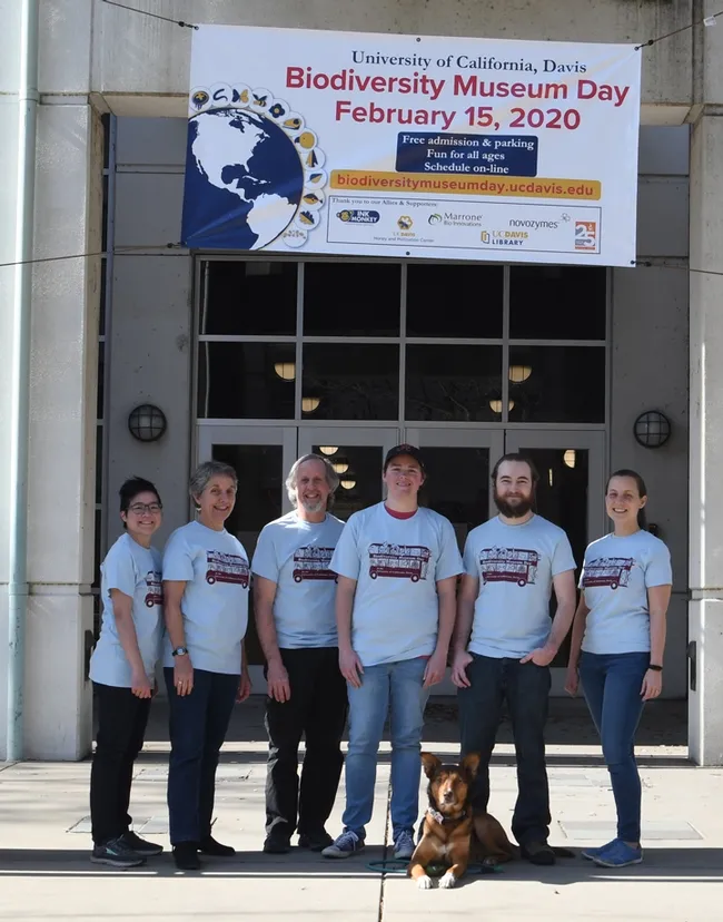Ready for UC Davis Biodiversity Museum Day are scientists (from left) Ivana Li, biology lab manager; Lynn Kimsey, director of the Bohart Museum of Entomology; Steve Heydon, Bohart Museum senior museum scientist; Lacie Newton, doctoral student, Jason Bond lab; Brennen Dyer, lab assistant, Bohart Museum; and Rebecca Godwin, doctoral candidate, Jason Bond lab. In front is Juniper, Ivana Li's dog. (Photo by Kathy Keatley Garvey)