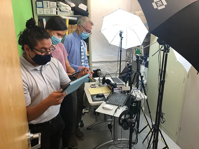 UC Davis distinguished professor Walter Leal (far right) preparing for the chat session of the international symposium on olfaction and taste. Assisting him are students Efrain Vasquez (foreground) and Kelly Brandt.