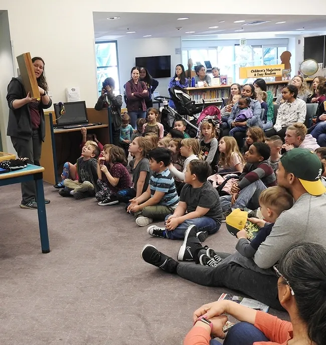 Tabatha Yang, the Bohart Museum of Entomology's education and outreach coordinator, shows a display of insects at a Vacaville Public Library event. The Bohart is in need of traveling display boxes and is raising funds. (Photo by Kathy Keatley Garvey)