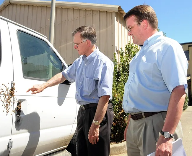 In this image, taken Aug. 1, 2008, Extension apiculturist Eric Mussen (left) talks to vanpool&nbsp;driver&nbsp;Keir&nbsp;Reavie, head of the Biological and Agriculture Sciences Department at Shields Library, about the bees that "hitched" a ride on a commuter van traveling from El Cerrito to the UC Davis campus. (Photo by Kathy Keatley Garvey)