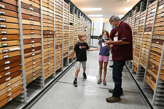 Let's go see the morpho butterflies! Niccoli Zebouni, 7, and his sister, Clio,9, chat with Bohart associate Greg Kareofelas. (Photo by Kathy Keatley Garvey)