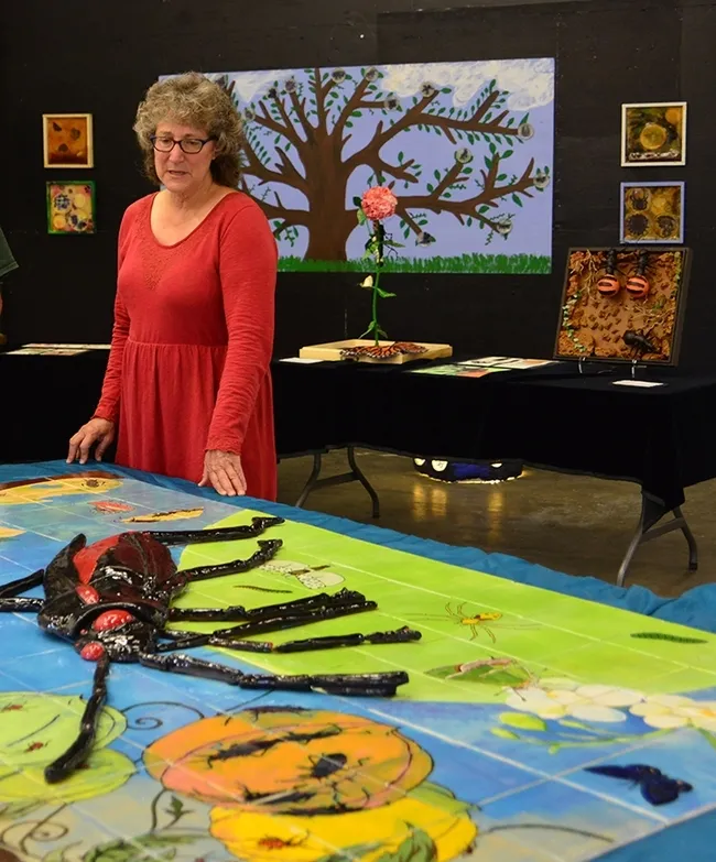 In this 2015 art show photo, UC Davis professor Diane Ullman looks over the work that her students created in her Entomology 001 class, "Art, Science and the World of Insects." (Photo by Kathy Keatley Garvey)