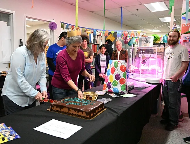 Folsom Lake College professor Fran Keller and UC Davis professor Lynn Kimsey cut the cake. At right is Bohart collection manager Brennen Dyer. (Photo by Kathy Keatley Garvey)