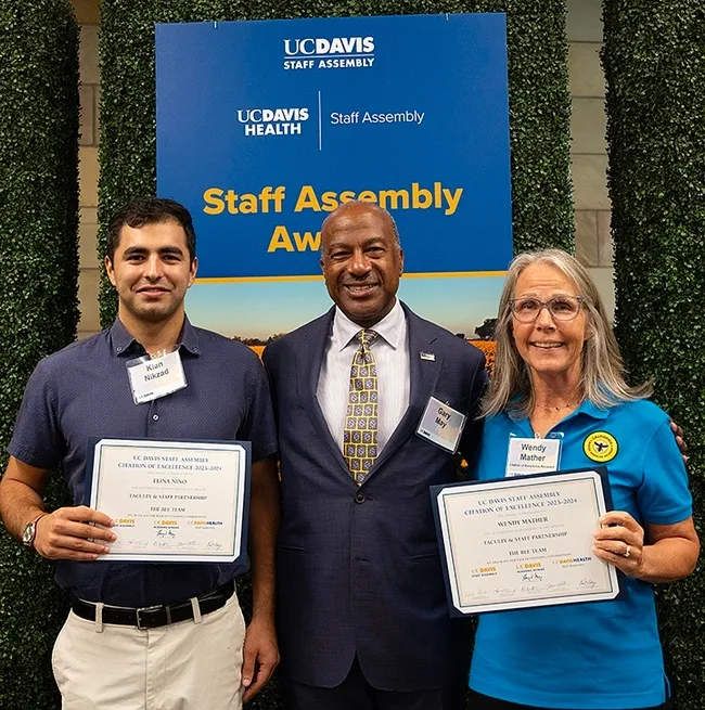 UC Davis Chancellor Gary May congratulates the California Master Beekeeper Program. With him are co-program managers Wendy Mather and Kian Nikzad. (Photo by Kathy Keatley Garvey)