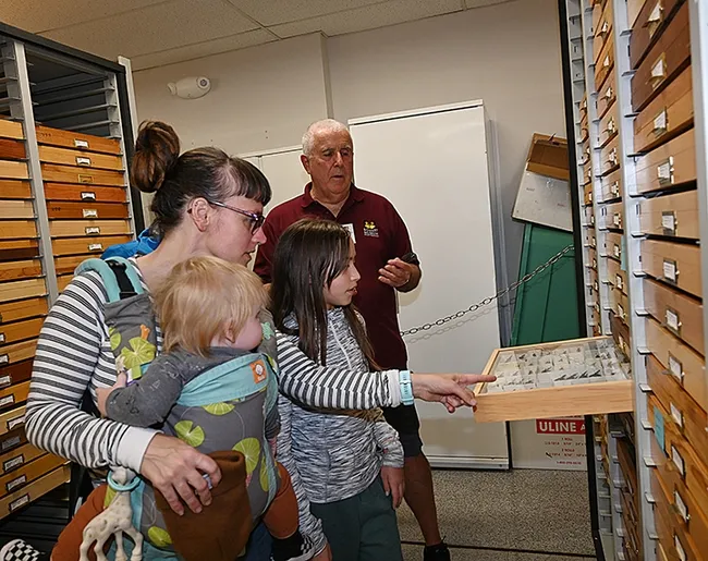 Entomologist Jeff Smith, curator of the lepidoptera collection at the Bohart Museum of Entomology, chats with Sacramento residents Skylan Potter, 11, and her mother, Camille Potter, holding son, Kehlan. (Photo by Kathy Keatley Garvey)