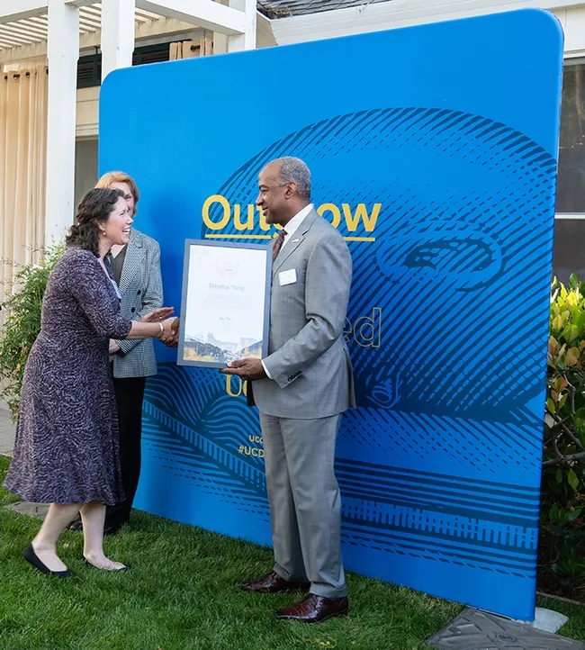 Tabatha Yang, education and outreach coordinator of the Bohart Museum of Entomology, greeting UC Davis Chancellor Gary May. (Photo by Anjie Cook)