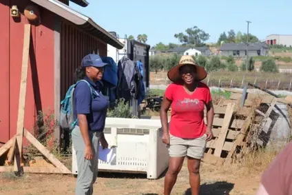 Chandra Richards talks with Joyce Nkhoma at a farm