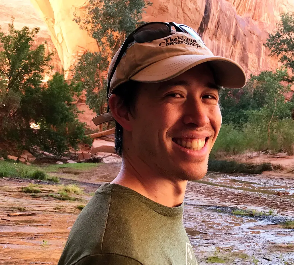 Photograph of Eric Middleton in an outdoor setting smiling into the camera.