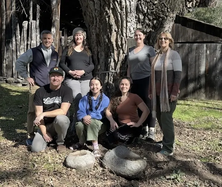 The UC ES Staff standing infront of a tree