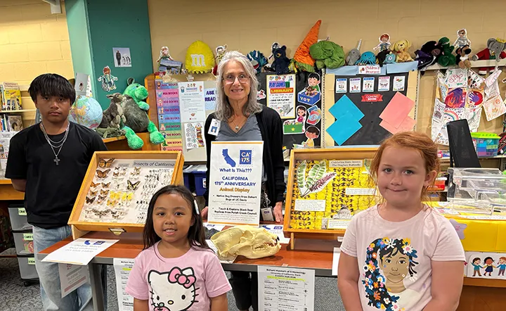 Library associate Galila Kitzes with patrons at the Children’s Section of the Fairfield Civic Center Library. The native insect specimen display from the Bohart Museum of Entomology runs through Wednesday, Sept. 10.