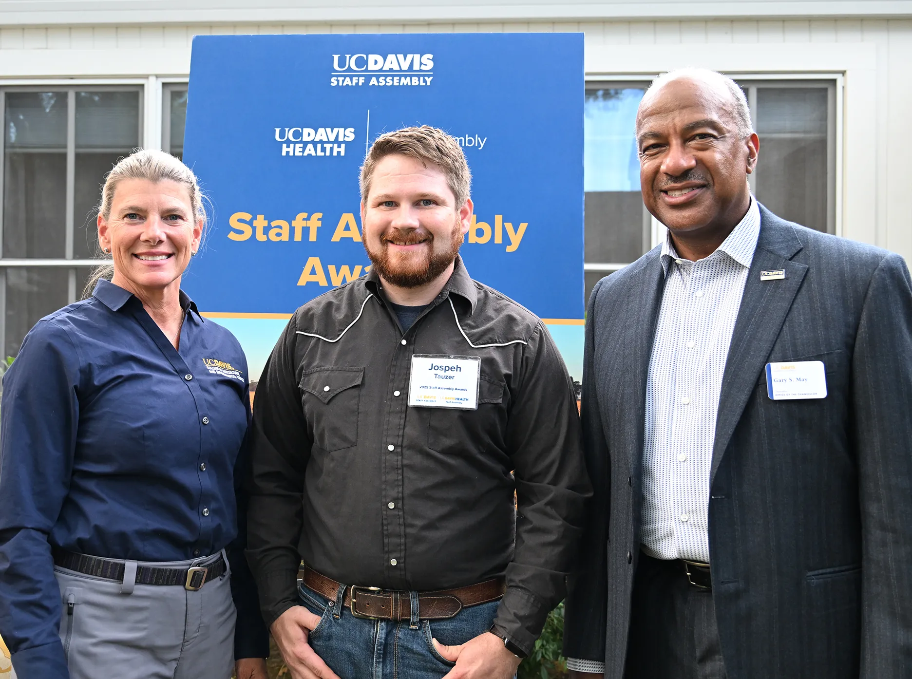Joining for a photo: Ashley Stokes, dean of the UC Davis College of Agricultural and Environmental Sciences; award recipient Joseph Tauzer, manager of the Harry H. Laidlaw Jr. Honey Bee Research Facility, and Chancellor Gary May. (Photo by Kathy Keatley Garvey)