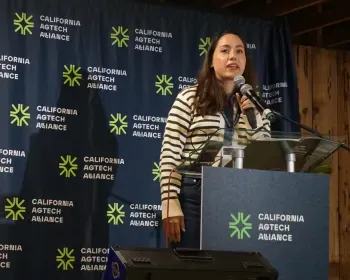 Karen Aceves speaks at lectern