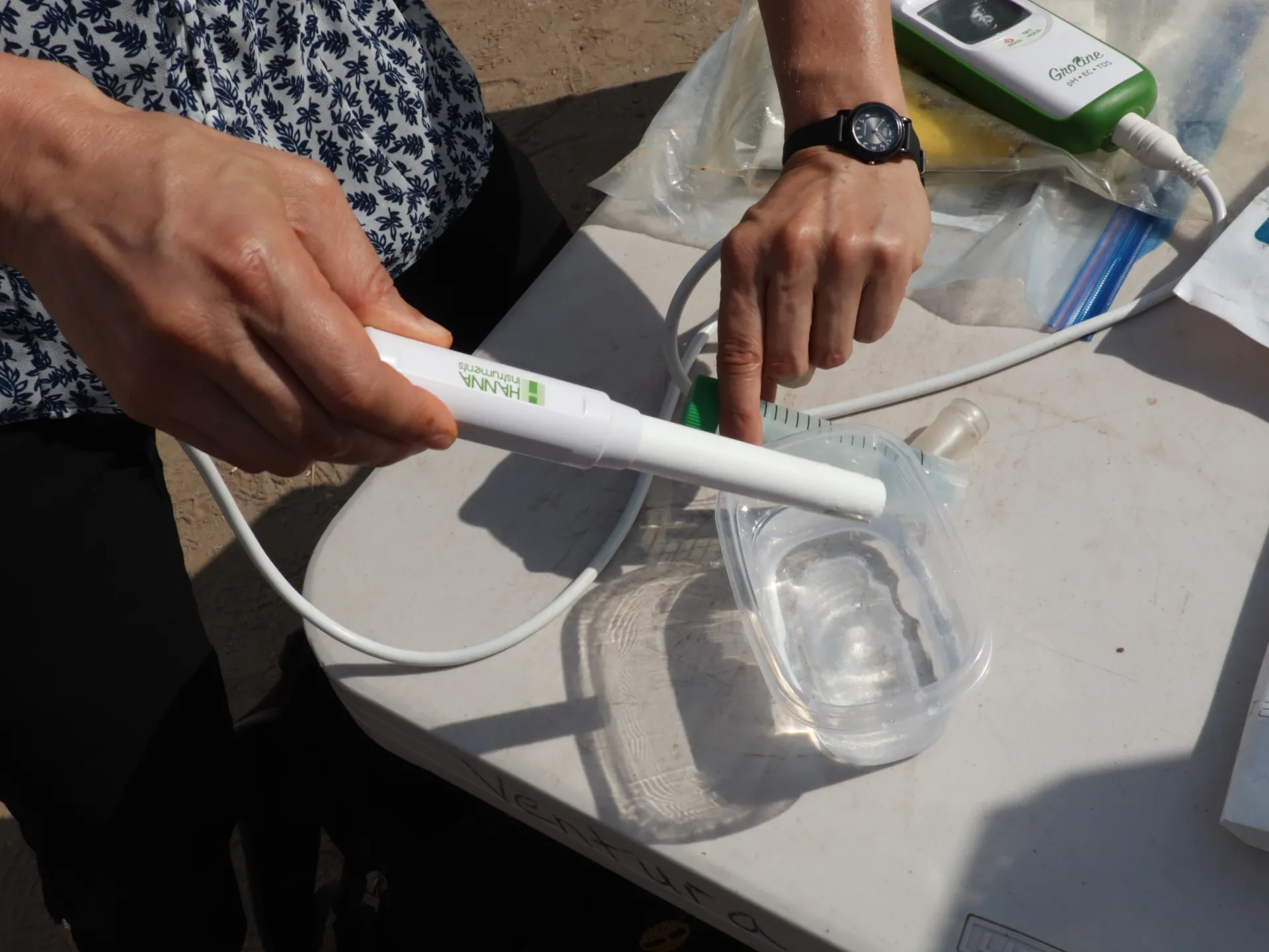 Someone's hands hold equipment for measuring soil nutrients