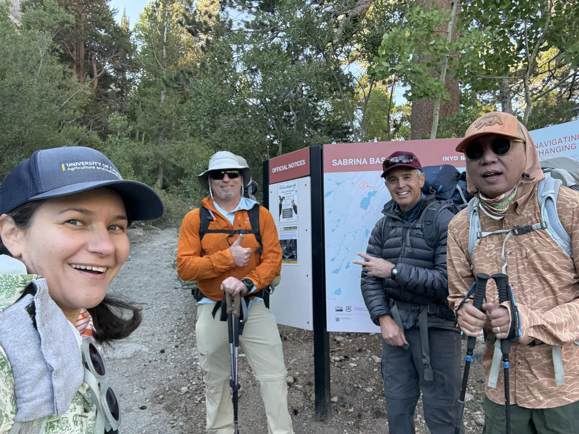 Four people stand by a sign that reads: Sabrina Basin