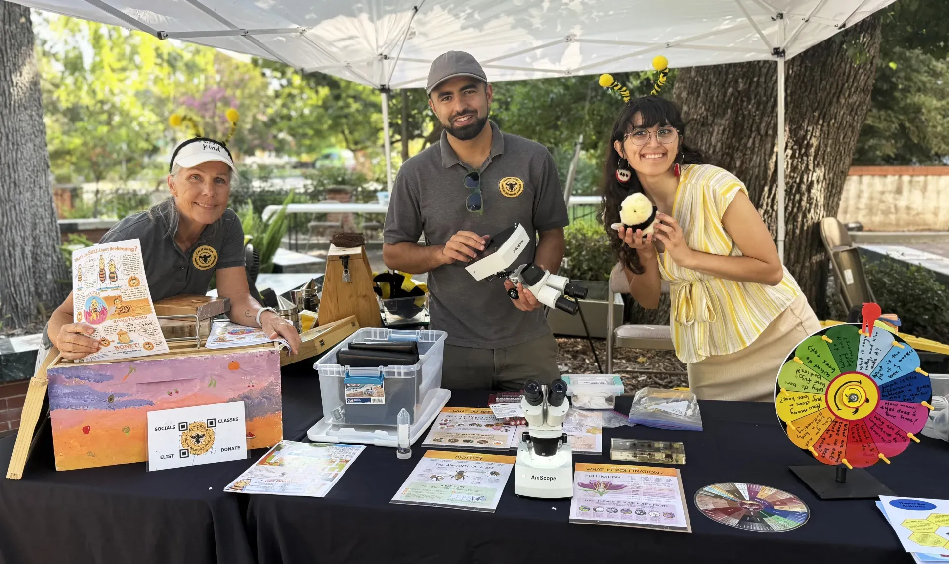 The California Master Beekeeper Program team (from left) Wendy Mather and Kian Nikzad, co-program managers; and Samantha Murray, education and garden coordinator of the UC Davis Bee Haven, get ready to greet the crowd at the Vacaville Museum Guild's annual Children's Party. (Photo by Kathy Keatley Garvey)