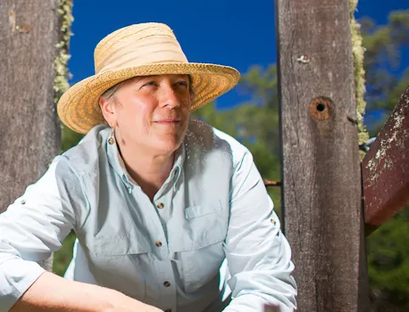 Headshot of Cynthia wearing a wide brim hat