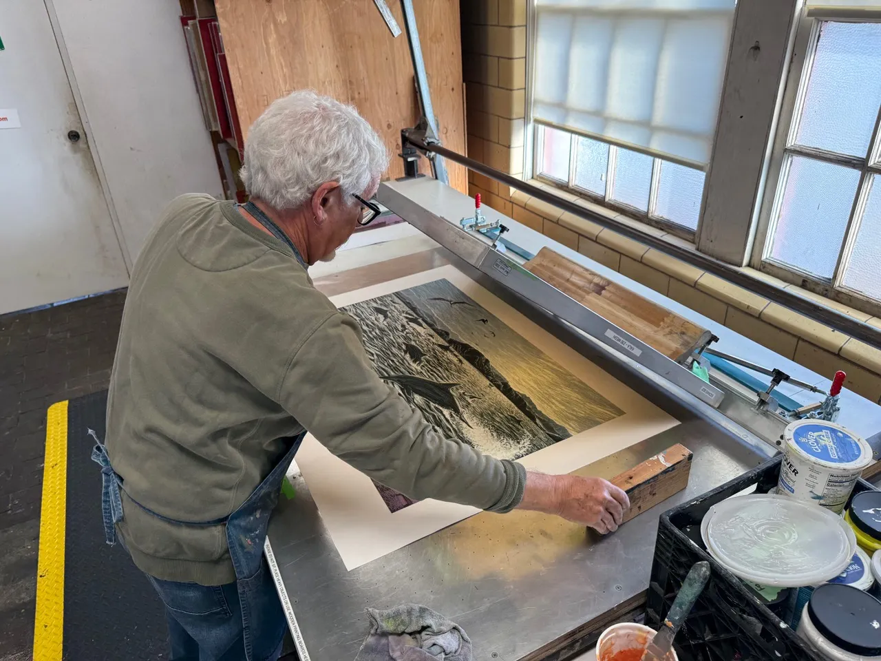 Jos Sances working on his latest project, featuring dolphins and a tanker.
