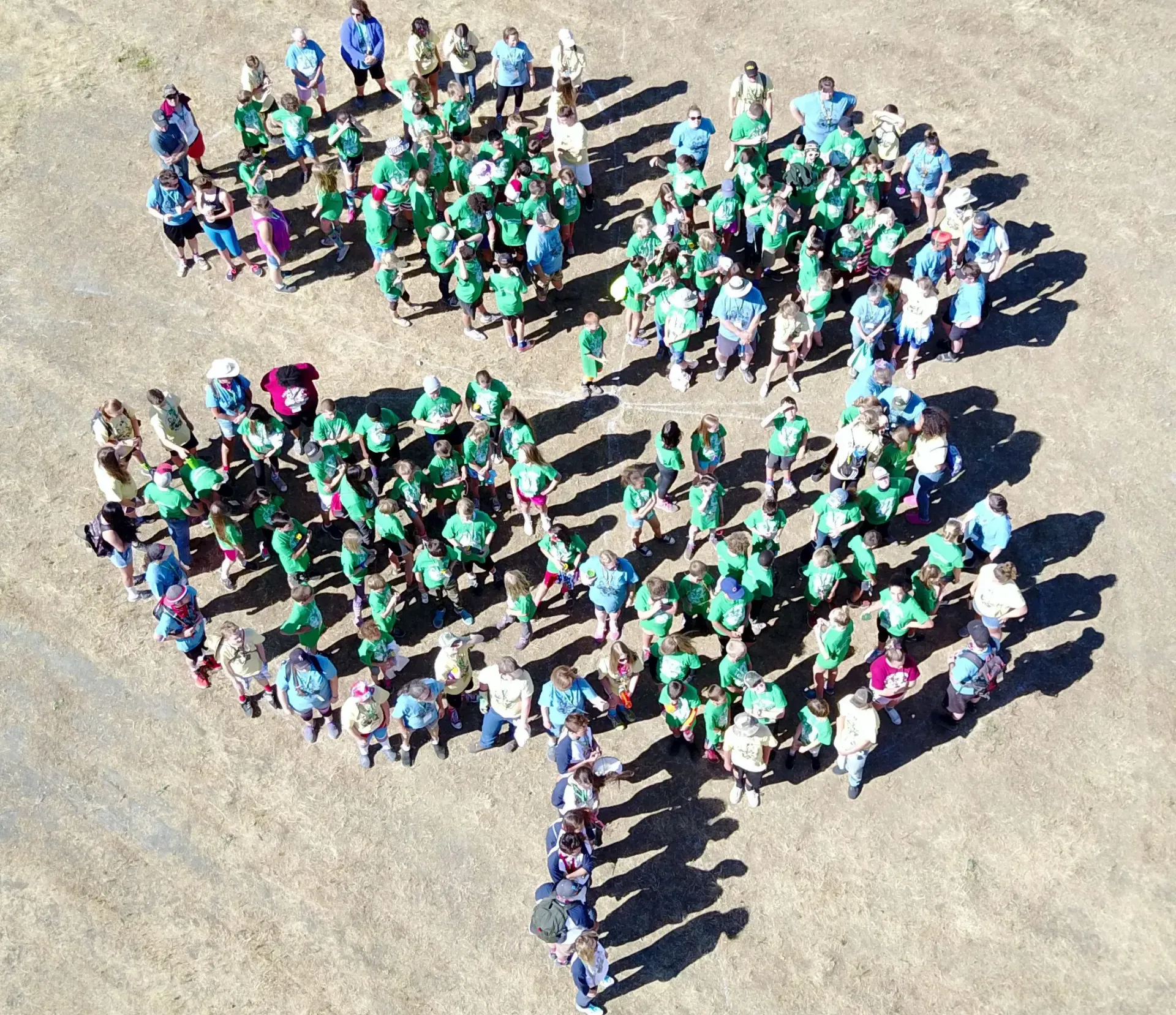 4-H youth and adults forming a 4-H clover.