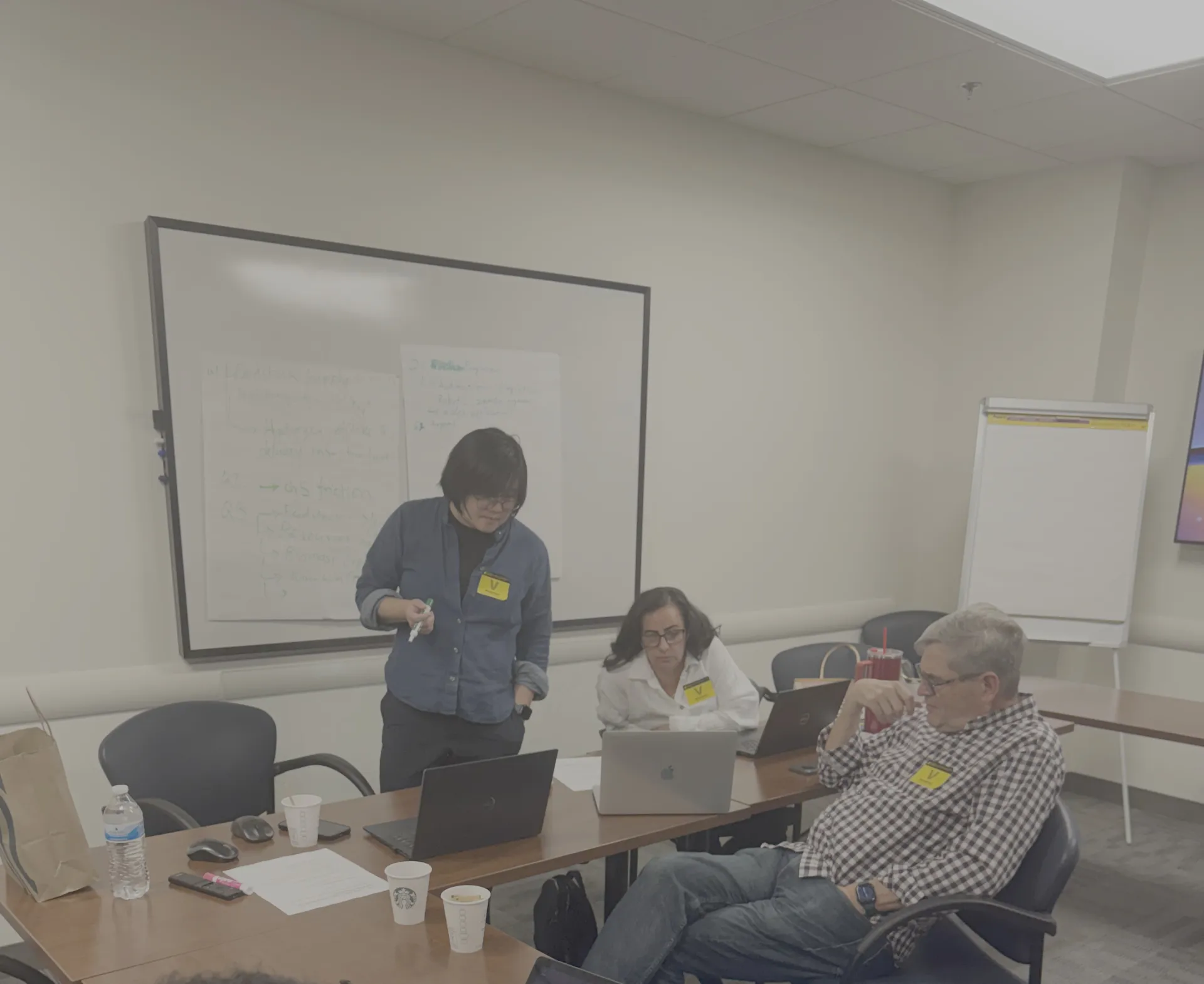 Workshop presenter speaks to other participants.