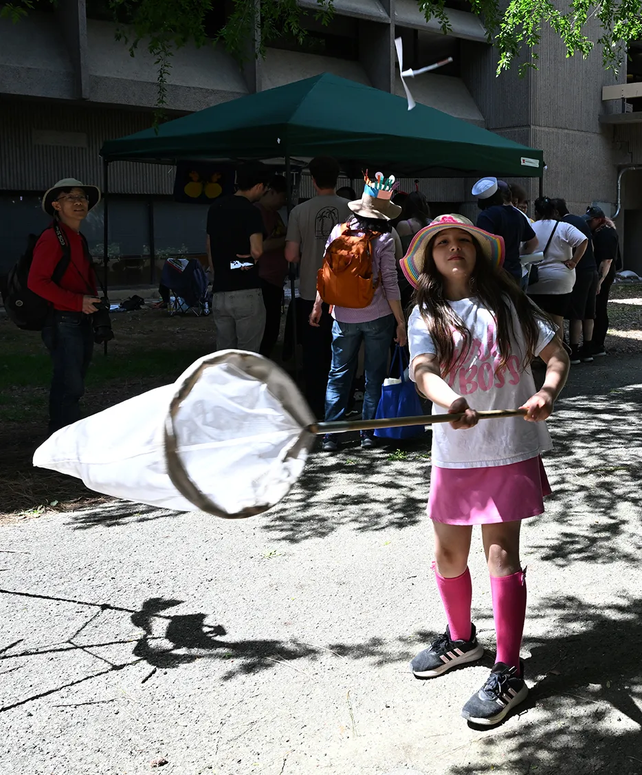 Doctoral candidate Carla-Cristina "CC" Edwards tries to net a paper butterfly.
