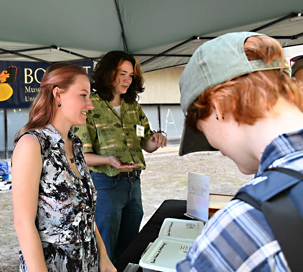 UC Davis Entomology Club members Elise (Eli) Piller&nbsp;(foreground) and Camille Stinson greet the crowd.