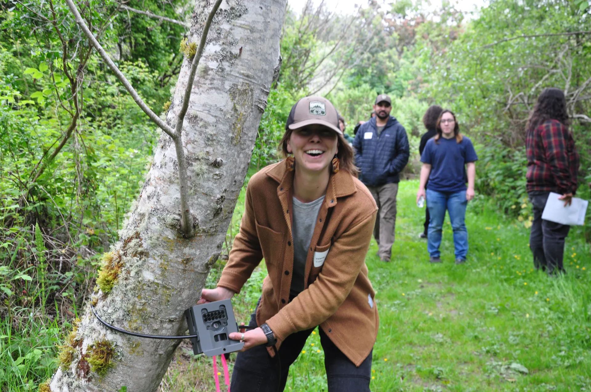 Tree School instructor demonstrating how to set up a wildlife camera.