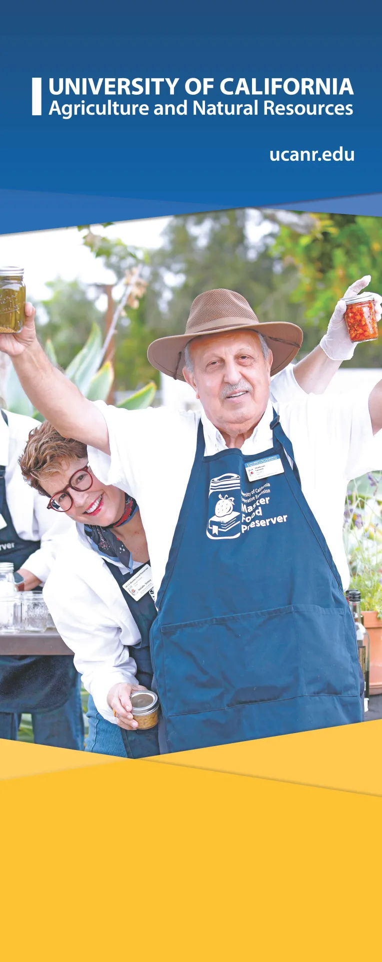 Large banner image of two Master Gardeners smiling and holding up jars of preserved fruits and vegetables