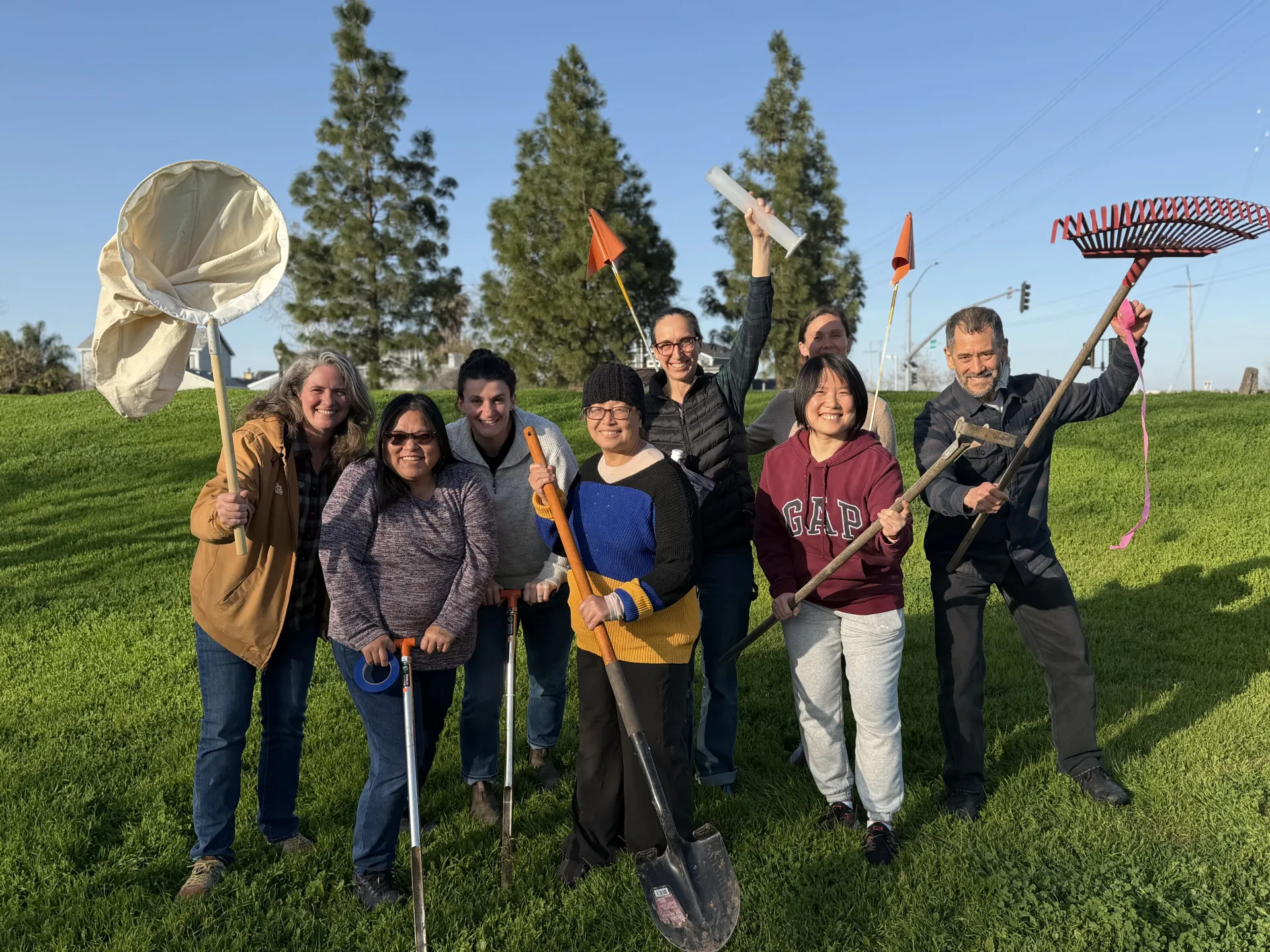 Fam Lee, second from the left, enjoys a light moment with colleagues (from left) Margaret Lloyd, Lindsey Klein, Ge Moua, Meaghan Donovan, Monica Drazba (back), Shufang Tian (front) and Phillip Fujiyoshi