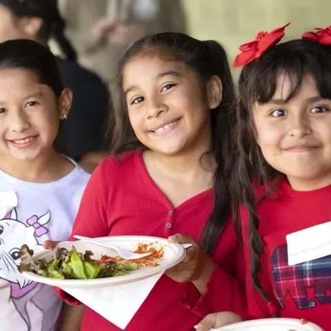 kids in a nutrition program smiling at camera