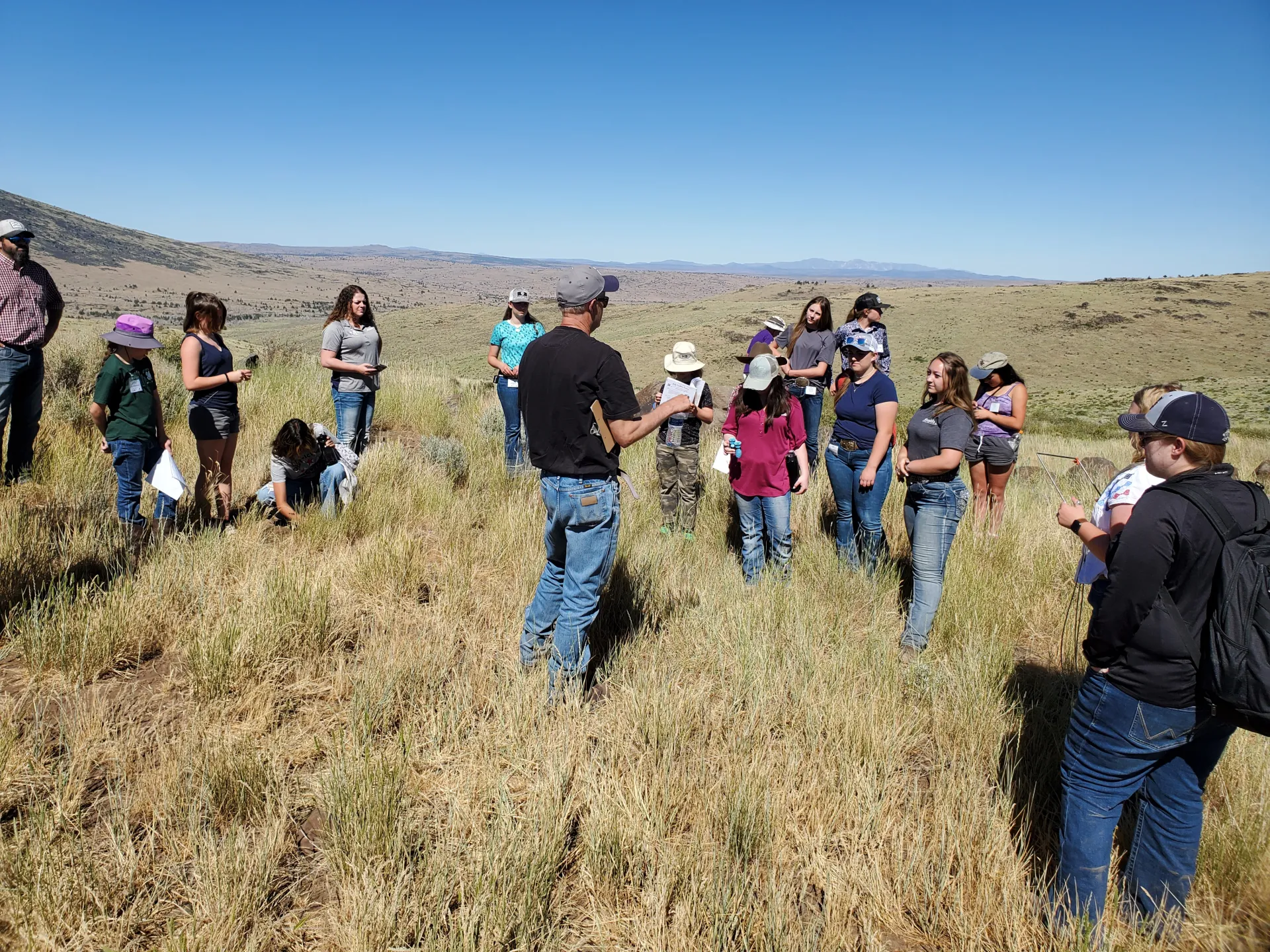 Youth gathered outdoors to learn about range management.