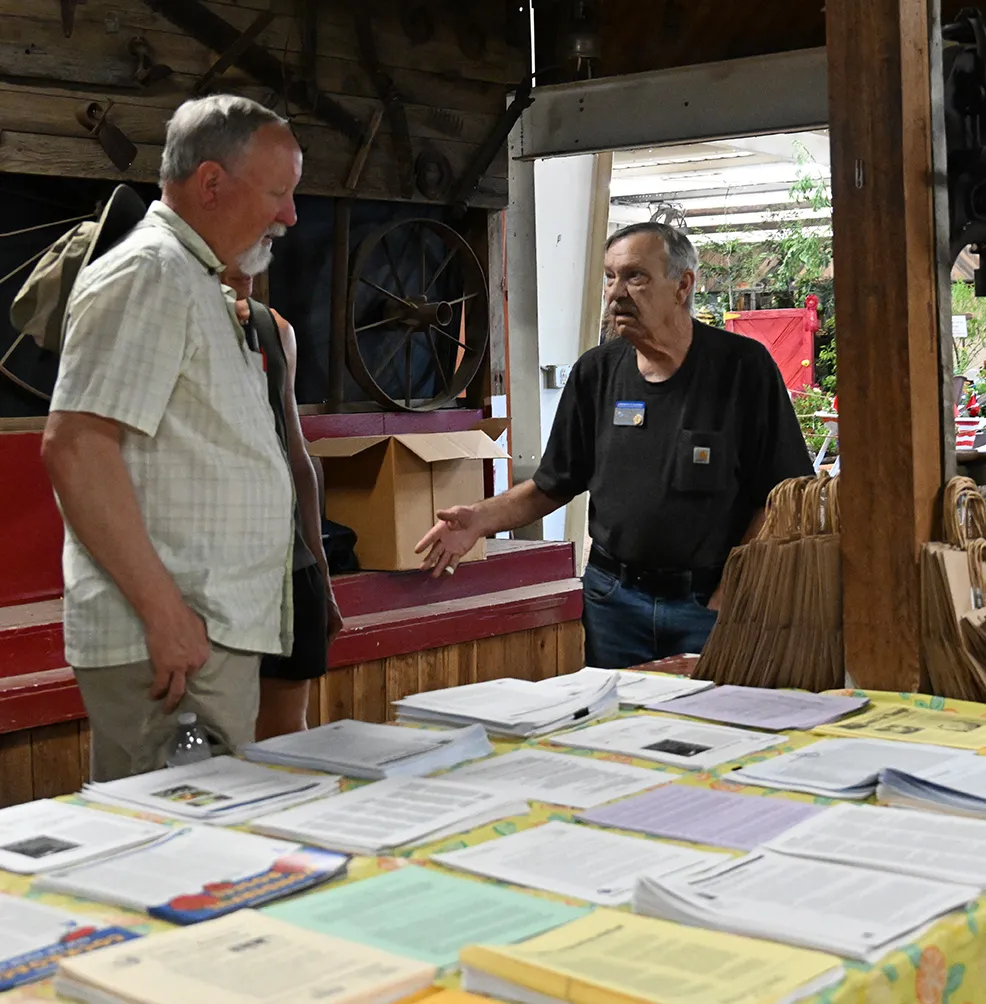 Dave Hutson (right) assists fairgoer Ron Wright with a gardener question. (Photo by Kathy Keatley Garvey)