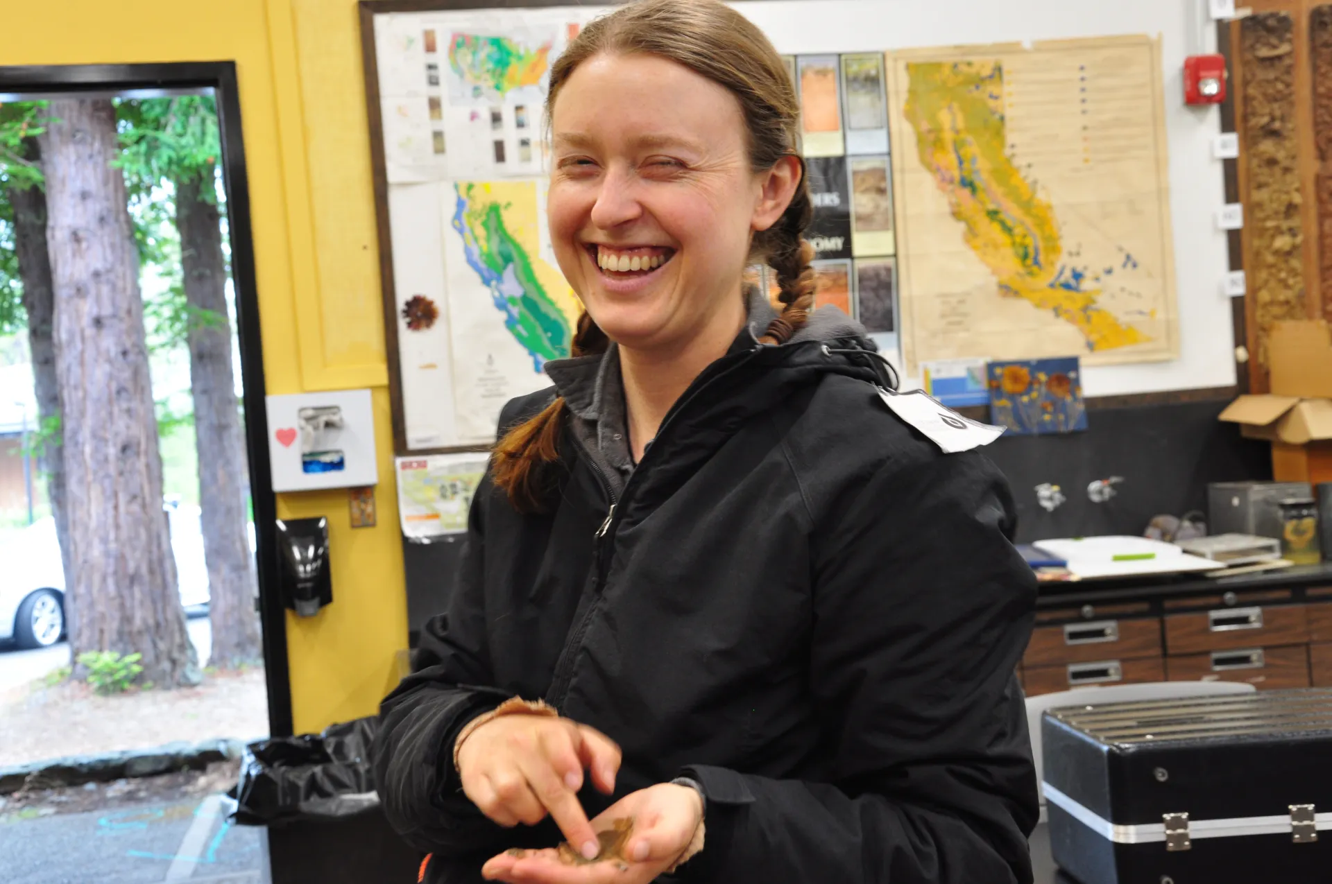 Person at CA Tree School shows a soil sample.