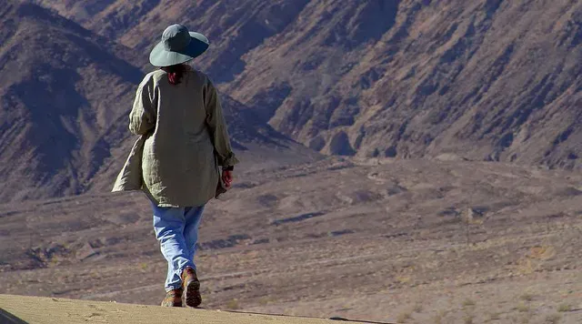 a woman walking in a desert
